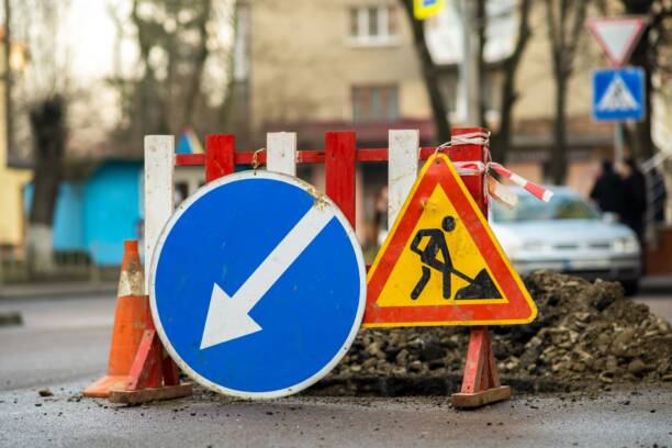 Warning street sign on road work site